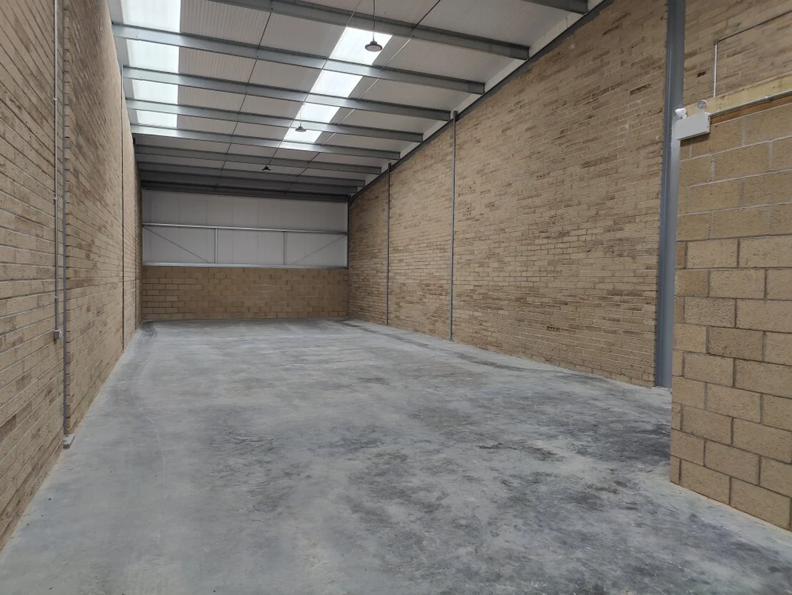 Clean industrial storage unit with racking and boxes