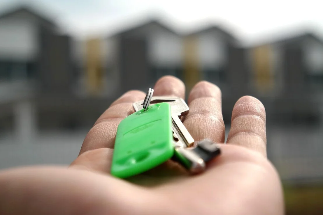 Landlord and tenant shaking hands in front of an industrial unit